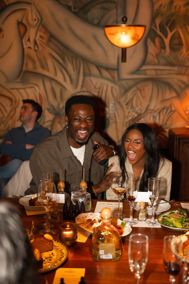 Guests laughing together at a Bulletpitch dinner